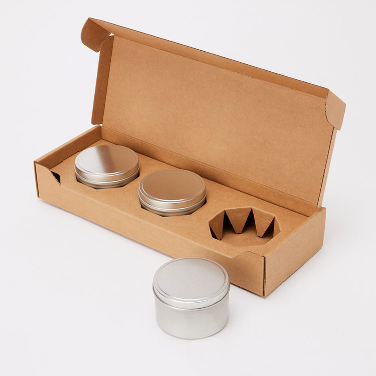 Shop packaging and shipping boxes for candles made with candle tins from Flush Packaging