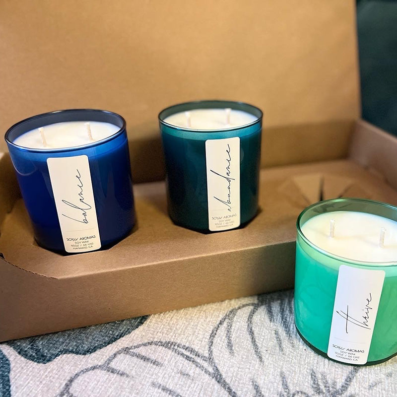 Three candles from Soyful Aromas made with the CandleScience Straight Sided Tumbler and packed with the Straight Sided Tumbler 3-Pack Shipping Box from Flush Packaging