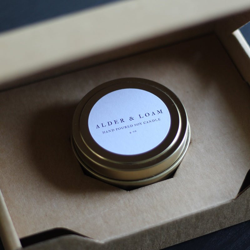 Candle from Alder and Loam Candles made with an 8 oz candle tin and packed with the 8 oz Candle Tin Shipping Box from Flush Packaging