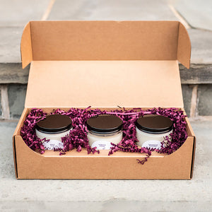 Candle Packaging for Saucy Candle Co. The box used is the 9 oz Straight Sided Glass Jar 3-Pack Shipping Box available for purchase from Flush Packaging